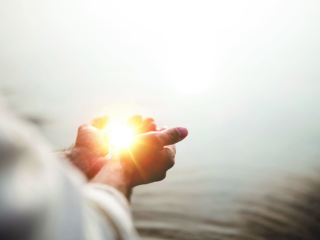 A beautiful shot of Jesus Christ holding hope and light in his palms with a blurred background; Shutterstock ID 1540652960; Project: -