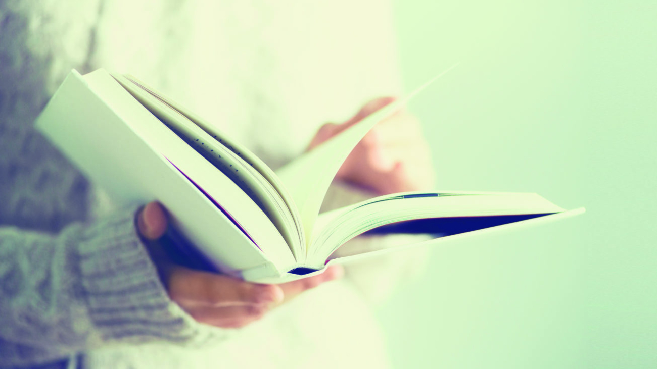 Young girl in white cardigan reading opened book. Copy space. lifestyle and school concept. Banner.; Shutterstock ID 790024390; Purchase Order: purchase_order